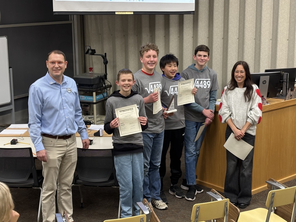 Four students posing with certificates wearing shirts that say "√4489"  The answer? 67  🤷 
