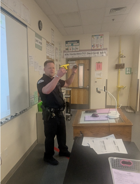 School Resource Officer Strassner pictured showing a taser to the class while giving a lesson.