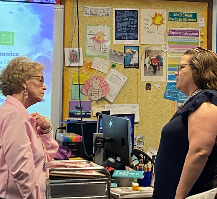 Two teachers talking with one another
