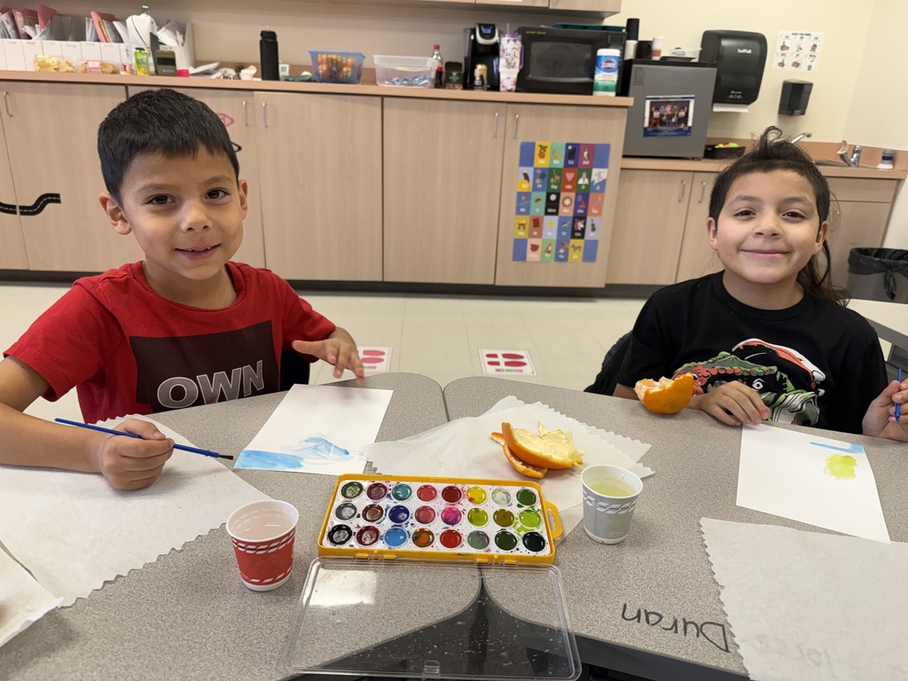 Students painting and smiling