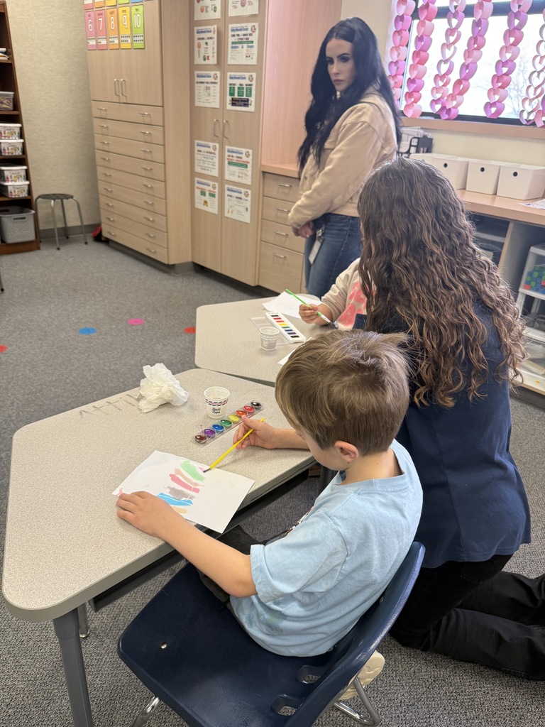 Students painting and smiling