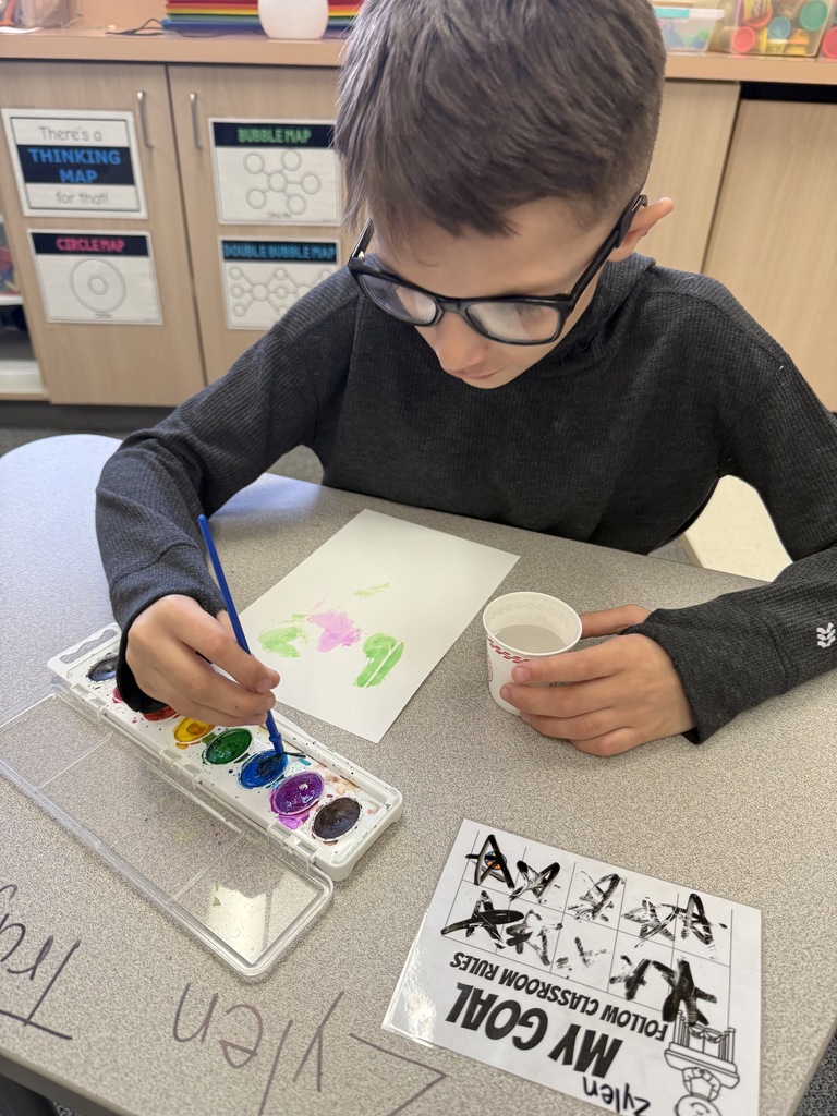 Students painting and smiling