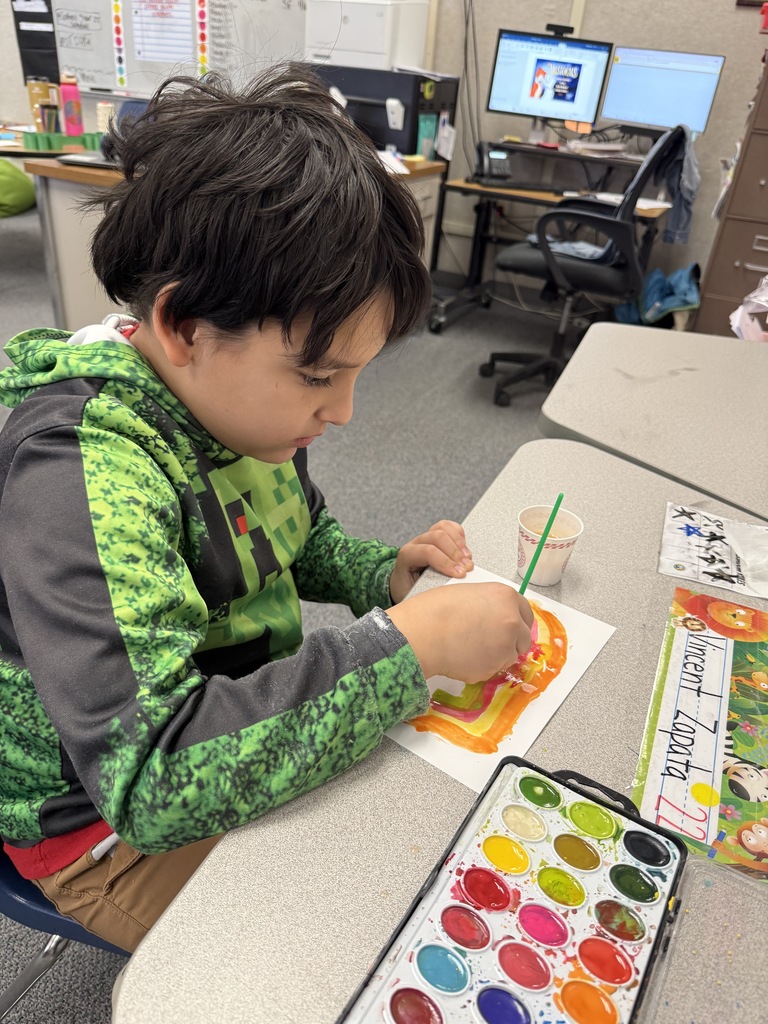 Students painting and smiling