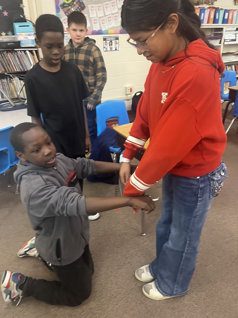 Students make letters with their bodies