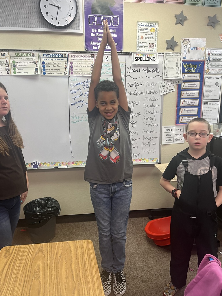 Students make letters with their bodies