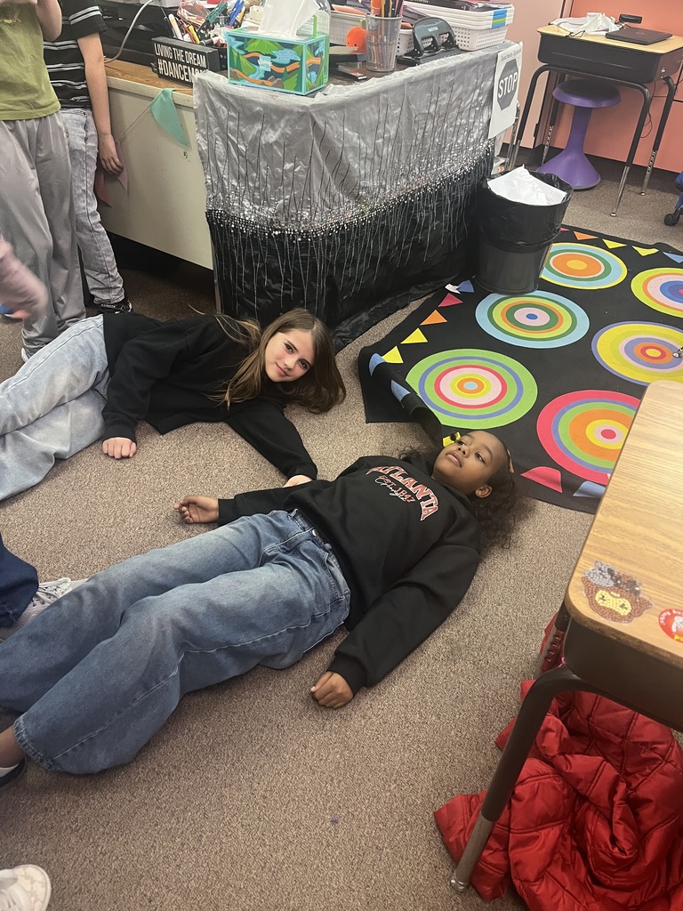 Students make letters with their bodies