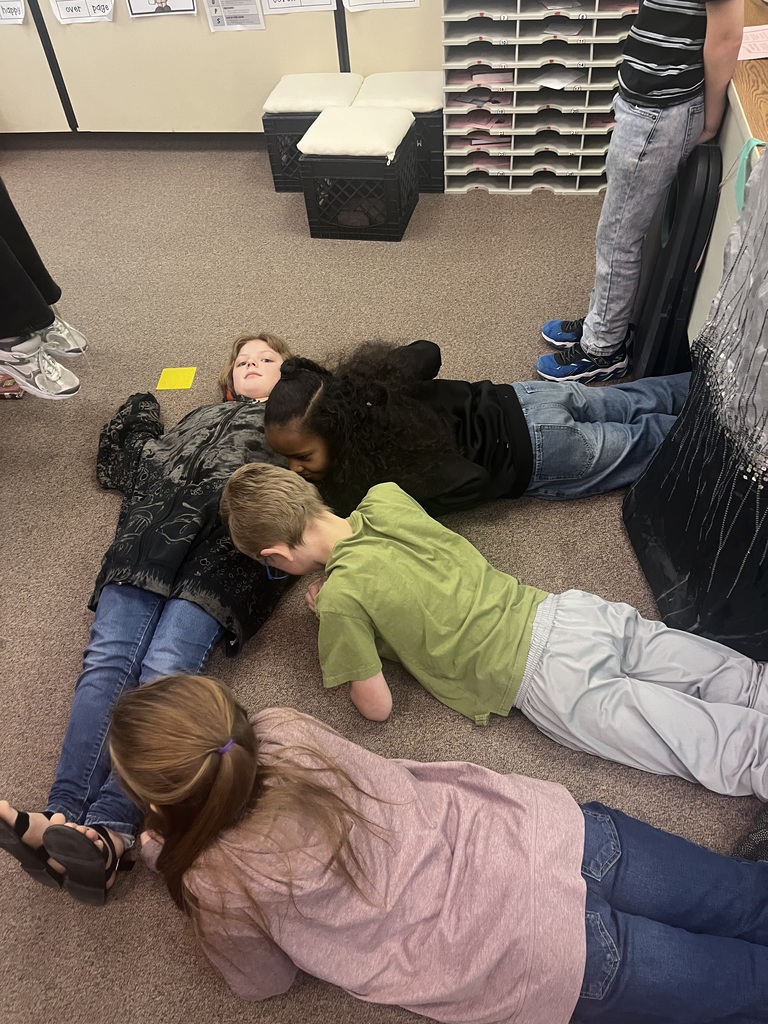 Students make an E with their bodies