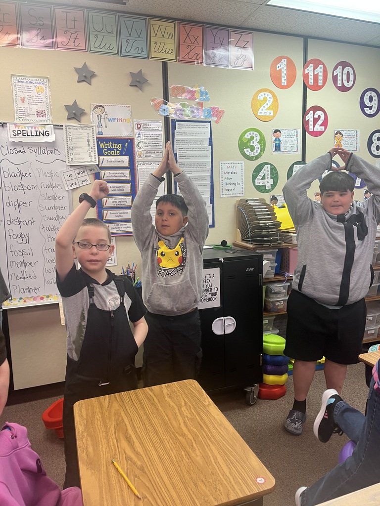 Students make letters with their bodies