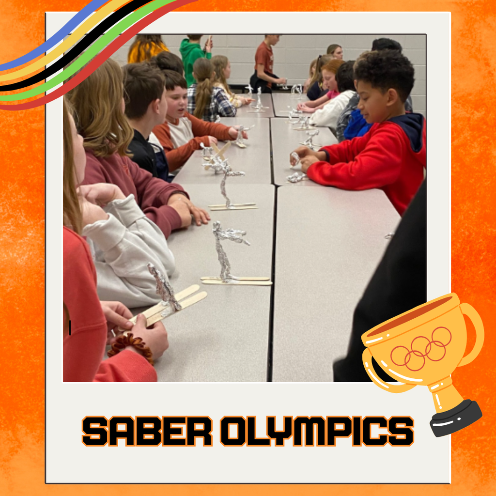 Students sitting at tables making their own "skiers" out of aluminum foil with tongue depressors as "skis"