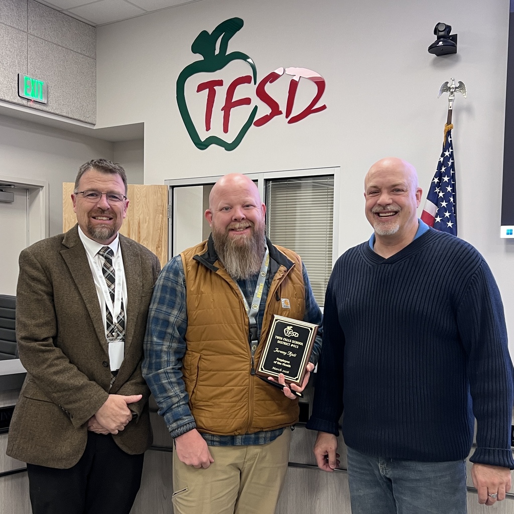 Employee of the Month pictured with superintendent and board member.