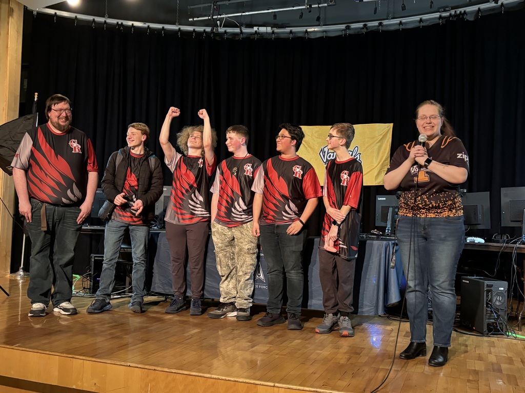 The team standing on stage proud of the place they received in the competition