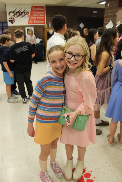 Two girls happily posing for picture.