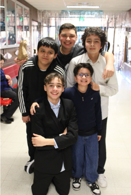 Five boys, dressed up, gathered together for a picture.
