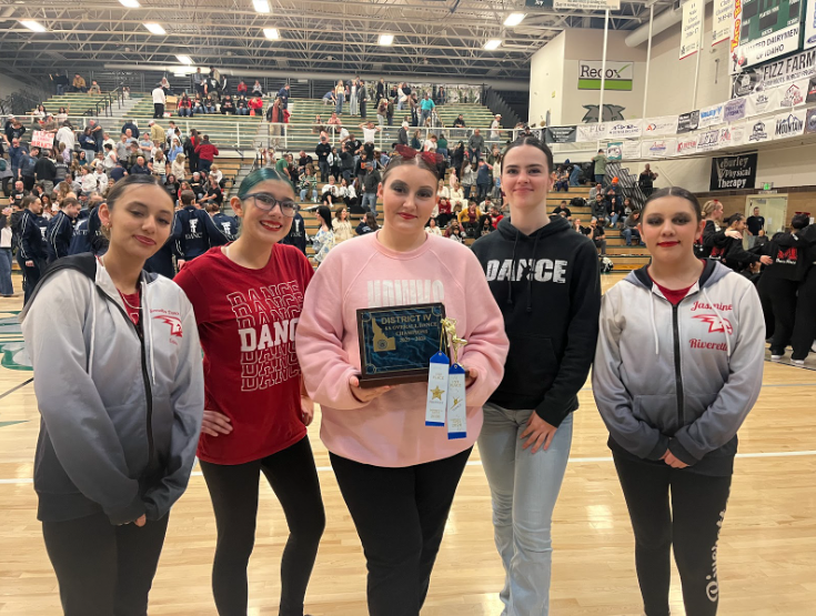 Five dancers pictured with a plaque and two ribbons