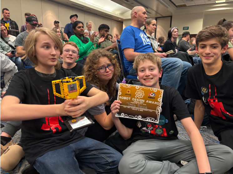 Five of the team members pictured together with a certificate and trophy 