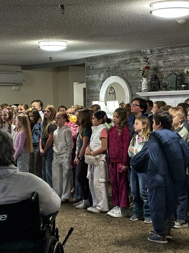 Kids singing at retirement home