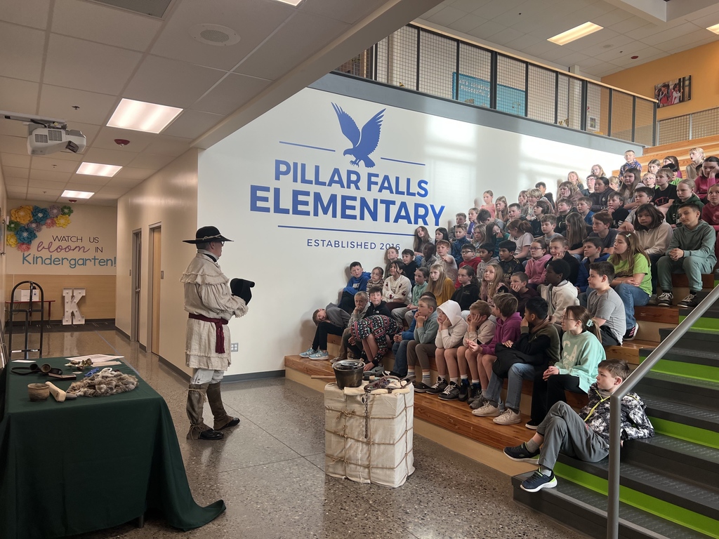 kids watching a presentation about mountain men