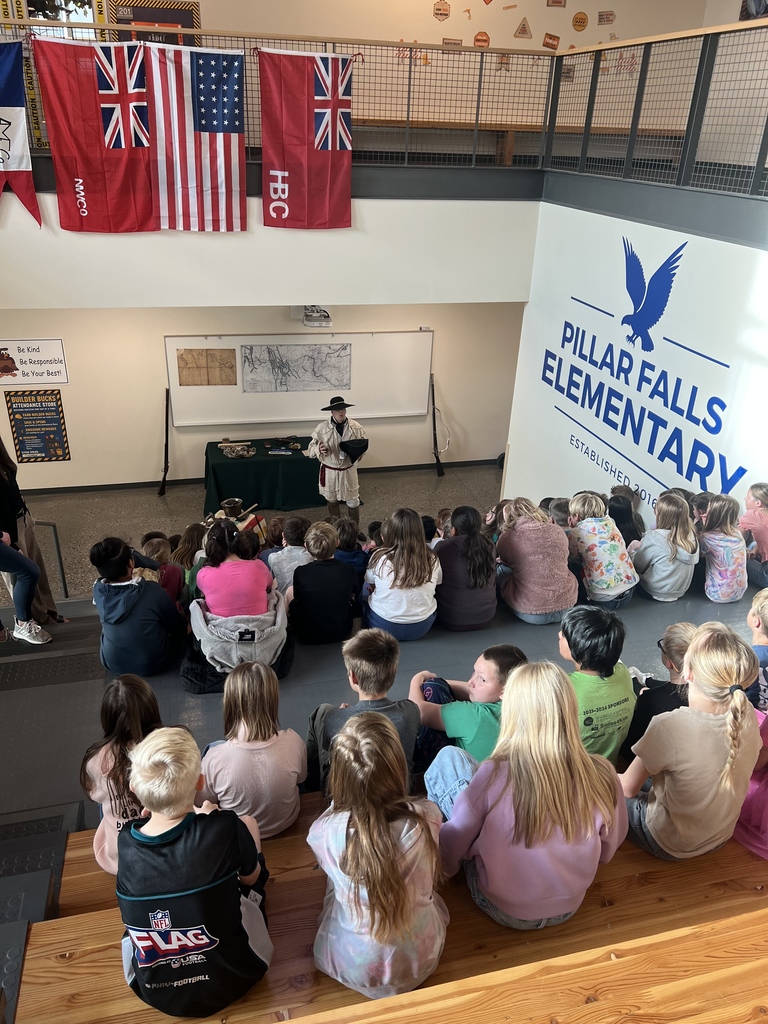 kids watching a presentation about mountain men