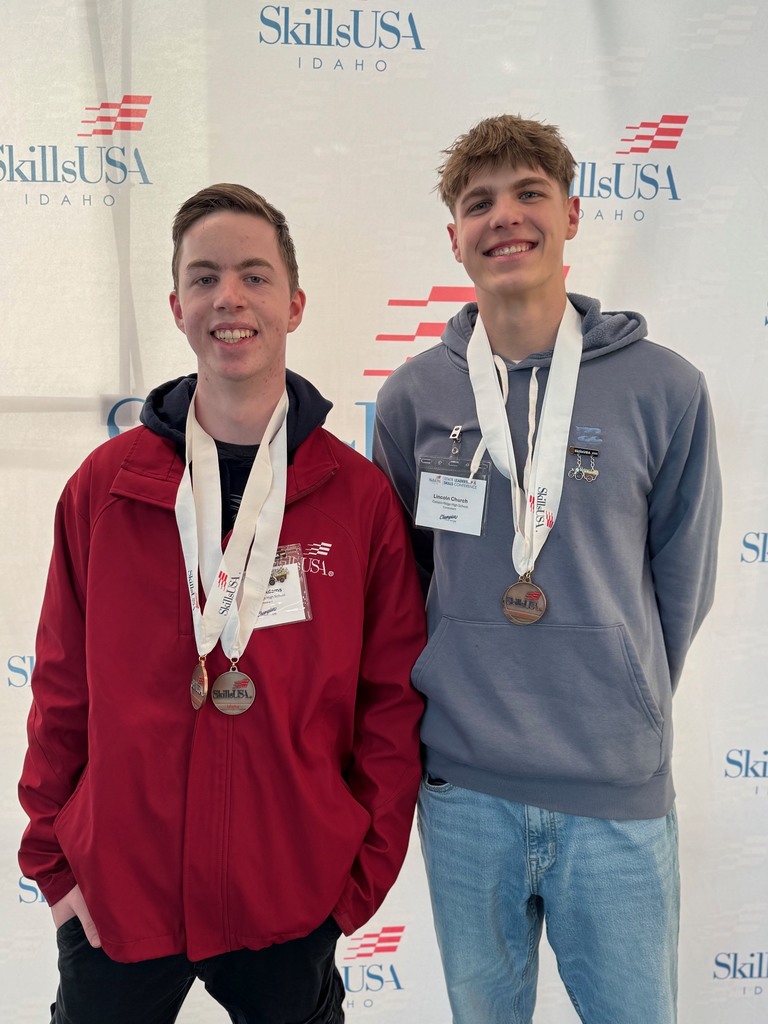 Two students wearing medals