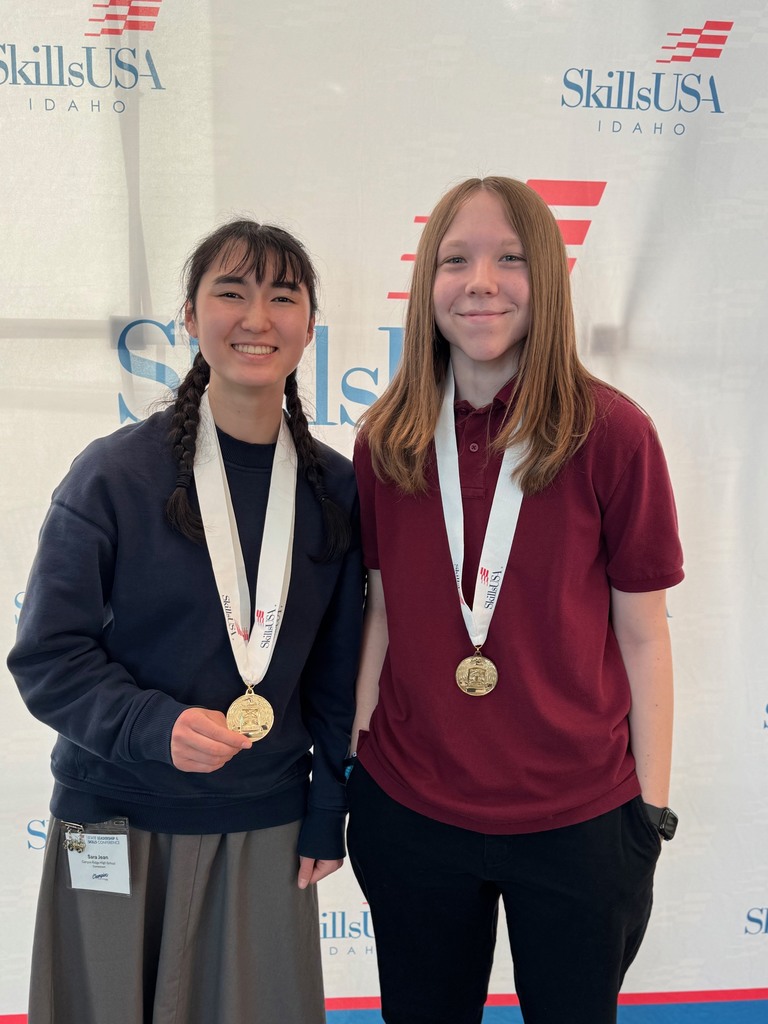 Two students wearing medals