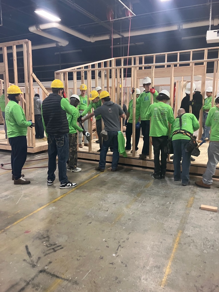 The group putting together the framing for walls.