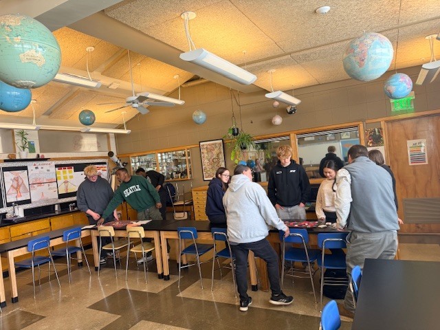 Students going station to station, playing their peer's games along the way