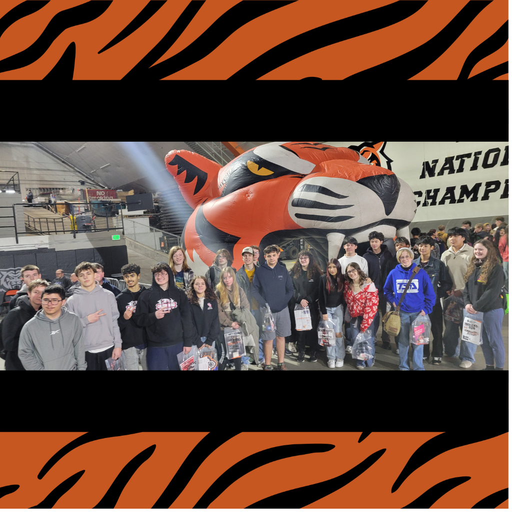 Students gathered together at the expo in front of a giant inflatable tiger head