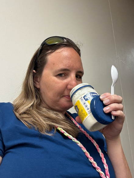 Teacher smelling an open Best Foods brand mayonnaise jar filled with "mayonnaise" while holding a spoon