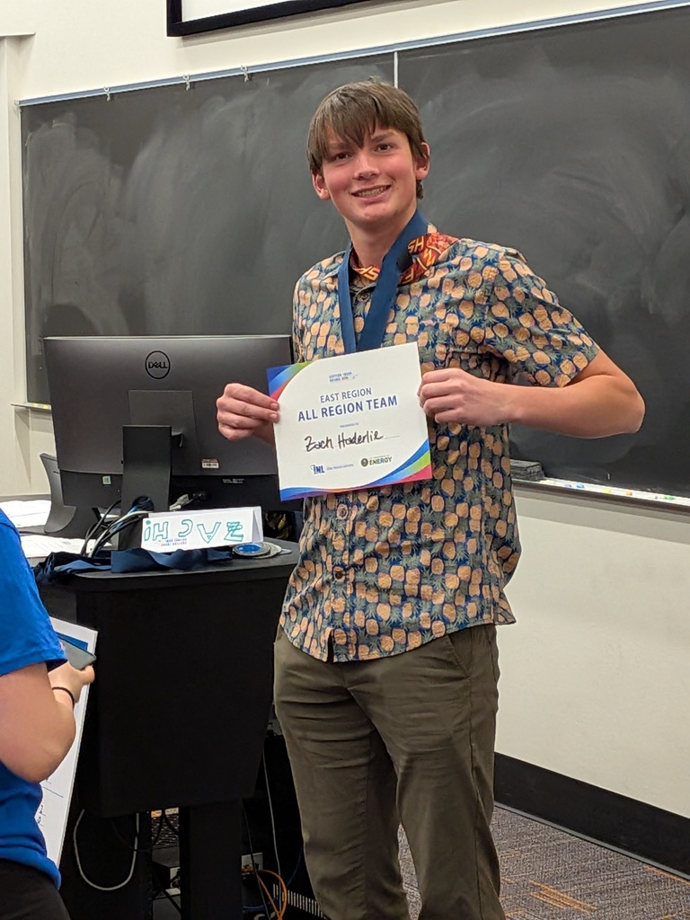 Zach Haderlie holding up his certificate for All Region Team