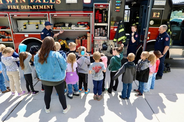 students listening to firefighters