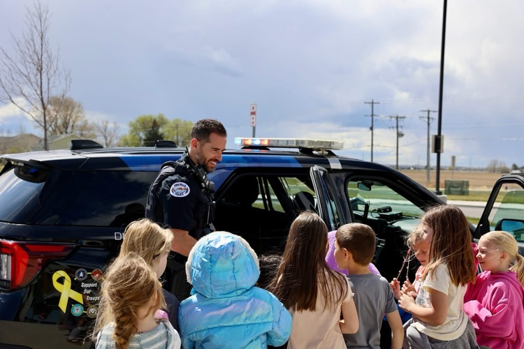 Students listening to a police officer