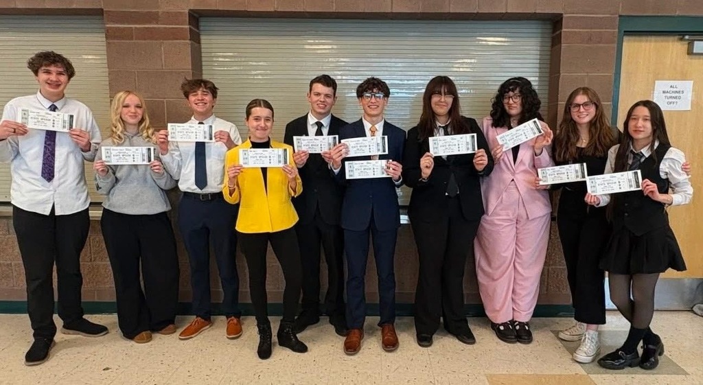 10 students stand showing off their awards