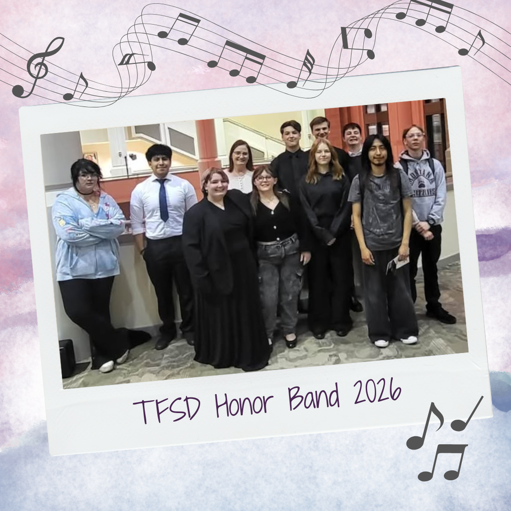 Group shot of band students: everyone’s smiling… except one very reluctant participant on the far left who may be plotting her escape.