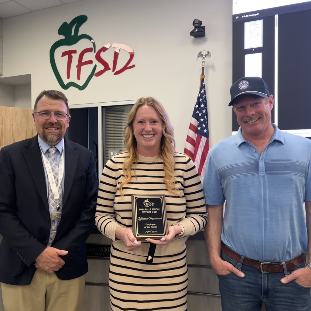 Employee of the Month pictured with superintendent and board member.