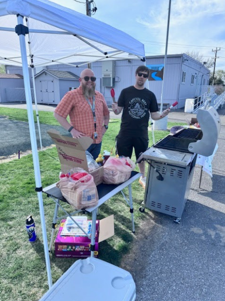 Two staff members enthusiastically manning the grill