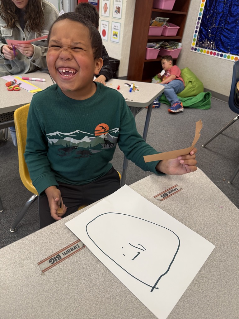 Students smiling during art