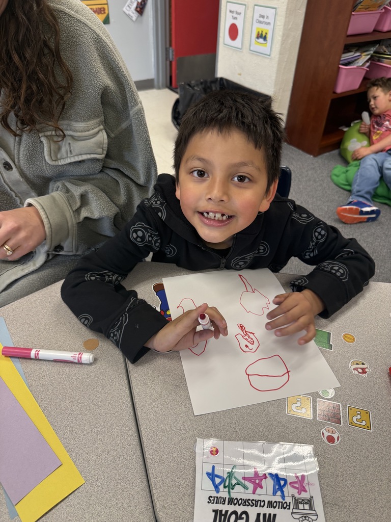 Students smiling during art