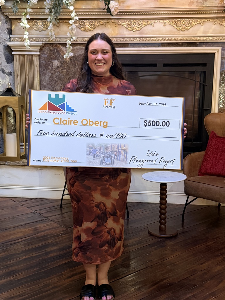 Ms. Oberg smiling with award