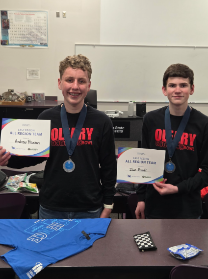 Ian and Andrew wearing their medals and holding up their All-Region certificates