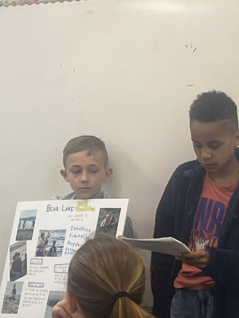 Student presents their family traditions with a poster.