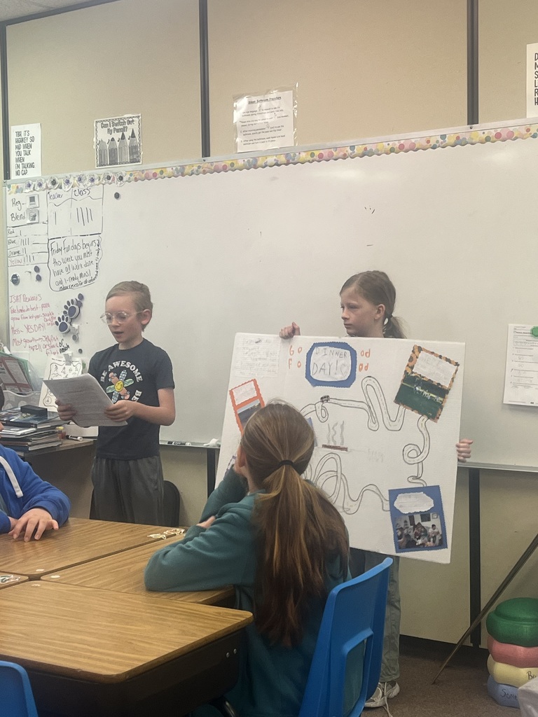 Student presents their family traditions with a poster.