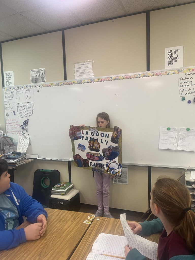 Student presents their family traditions with a poster.