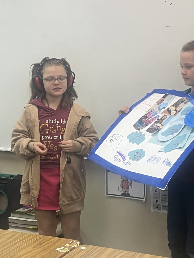 Student presents their family traditions with a poster.