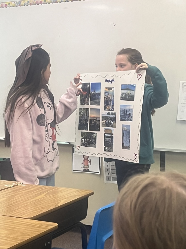 Student presents their family traditions with a poster.