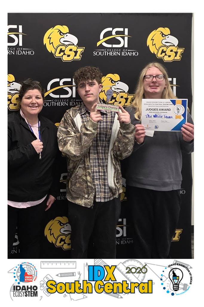Two students and an advisor pictured holding a "Judge's Choice" Trophy and certificate.