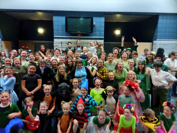 The entire cast grouped together, happily, for a picture.