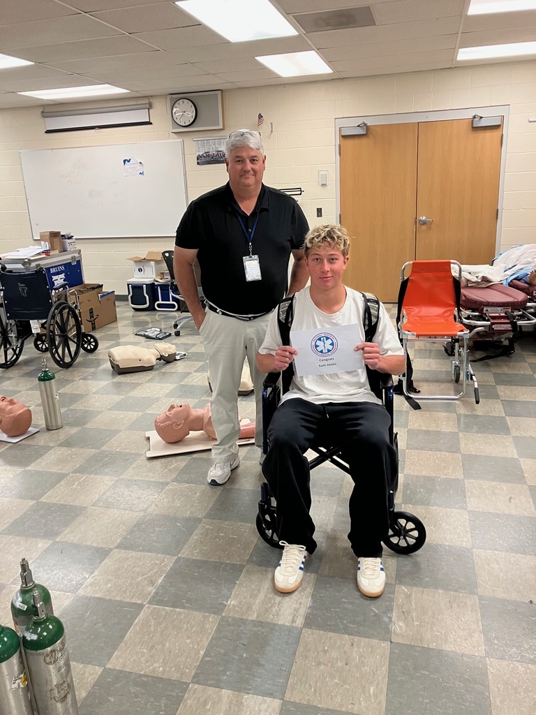 Sam Jones with Mr. Showers holding his EMT Certification Certificates