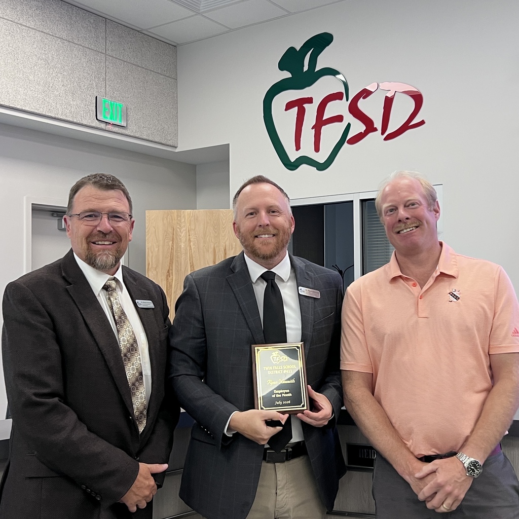 Employee of the Month pictured with superintendent and board member.