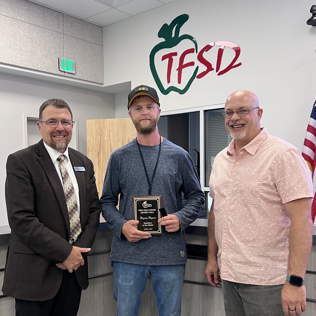 Employee of the Month pictured with superintendent and board member.
