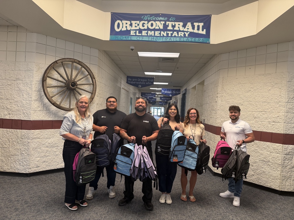 Oregon Trail Staff and others smiling with donations